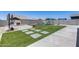 Beautiful backyard featuring artificial grass, pavers, outdoor fireplace, and a playground at 41650 W Barcelona Dr, Maricopa, AZ 85138