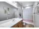 Bathroom featuring a white countertop, wood cabinets, and a shower/tub combination with a striped curtain at 41650 W Barcelona Dr, Maricopa, AZ 85138