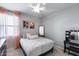 Bedroom with a full bed, pink curtains, and decorative mirror on the wall at 41650 W Barcelona Dr, Maricopa, AZ 85138
