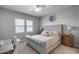 Cozy bedroom with tufted headboard, neutral tones, and ample natural light at 41650 W Barcelona Dr, Maricopa, AZ 85138