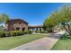 Community clubhouse featuring stone accents, manicured lawns and a private, paved walking path at 41650 W Barcelona Dr, Maricopa, AZ 85138