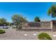 Community entrance sign with stone details, landscape, and clear blue sky at 41650 W Barcelona Dr, Maricopa, AZ 85138