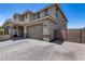 Two-story home features a large garage, brick driveway, neutral color palette, and gated side entrance at 41650 W Barcelona Dr, Maricopa, AZ 85138