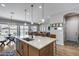 Modern kitchen island with stainless steel sink, pendant lights, and open floor plan at 41650 W Barcelona Dr, Maricopa, AZ 85138