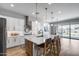 Open concept kitchen with island seating, stainless steel appliances, and white cabinetry at 41650 W Barcelona Dr, Maricopa, AZ 85138