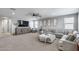 Large Gathering room featuring a sectional sofa, entertainment center, and neutral decor at 41650 W Barcelona Dr, Maricopa, AZ 85138
