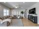 Comfortable living room with large sectional sofa, ceiling fan, and decorative accents at 41650 W Barcelona Dr, Maricopa, AZ 85138