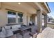 Covered patio with wicker furniture, perfect for outdoor entertaining at 41650 W Barcelona Dr, Maricopa, AZ 85138