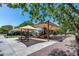 Community playground with covered picnic tables, play structures, and landscaped surroundings at 41650 W Barcelona Dr, Maricopa, AZ 85138