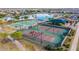 Aerial view of the community amenities including a lake, multiple sports courts, and playground at 41926 W Sussex Dr, Maricopa, AZ 85138