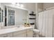 This bathroom features a stylish sink, a large mirror, and a clean shower area at 41926 W Sussex Dr, Maricopa, AZ 85138
