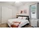 A bright bedroom features a comfortable bed, a stylish lamp, and a cozy blanket at 41926 W Sussex Dr, Maricopa, AZ 85138