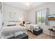 The bedroom is furnished with two beds and stylish accents, offering a cozy and inviting atmosphere at 41926 W Sussex Dr, Maricopa, AZ 85138
