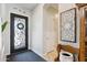 Welcoming entryway with decorative glass door and artistic wall decor at 41926 W Sussex Dr, Maricopa, AZ 85138