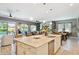 Bright kitchen showcasing a large island, pendant lighting, and open layout to dining and living spaces at 41926 W Sussex Dr, Maricopa, AZ 85138