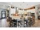 Stylish kitchen with an expansive island, bar stool seating, and updated appliances at 41926 W Sussex Dr, Maricopa, AZ 85138