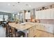 Open kitchen with a large island, white cabinetry, and modern appliances at 41926 W Sussex Dr, Maricopa, AZ 85138