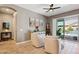 Bright living room with a view of the pool through a sliding glass door and tiled floors at 41926 W Sussex Dr, Maricopa, AZ 85138