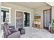 Cozy covered patio with comfortable seating, an outdoor TV, and view of the outdoor kitchen at 41926 W Sussex Dr, Maricopa, AZ 85138