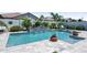 Relaxing pool with a charming rock waterfall feature and tiled patio with ample space for outdoor lounging at 41926 W Sussex Dr, Maricopa, AZ 85138