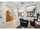 Stylish salon space with comfortable chairs and open views into other living areas at 41926 W Sussex Dr, Maricopa, AZ 85138
