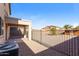 Fenced backyard featuring desert landscaping and a covered patio, offering a private outdoor space at 42564 W Palmyra Ln, Maricopa, AZ 85138