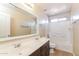 Bright bathroom with double vanity, and shower over tub at 42564 W Palmyra Ln, Maricopa, AZ 85138