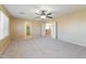 Large carpeted bedroom with a ceiling fan and views into a closet and hallway at 42564 W Palmyra Ln, Maricopa, AZ 85138