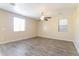 Bright bedroom featuring vinyl floors, natural light, and a ceiling fan at 42564 W Palmyra Ln, Maricopa, AZ 85138