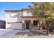 Two-story home with desert landscaping, covered porch with stone accents, and a two car garage at 42564 W Palmyra Ln, Maricopa, AZ 85138