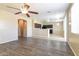 The living room flows into the open kitchen area and features vinyl floors and recessed lighting at 42564 W Palmyra Ln, Maricopa, AZ 85138
