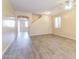 Open living room with vinyl floors, access to other rooms, and a ceiling fan at 42564 W Palmyra Ln, Maricopa, AZ 85138