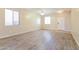 Spacious living room featuring vinyl floors, a ceiling fan, and plenty of natural light at 42564 W Palmyra Ln, Maricopa, AZ 85138