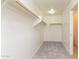 A carpeted walk-in closet with lighting and hanging racks at 42564 W Palmyra Ln, Maricopa, AZ 85138