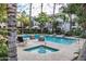 Community pool and hot tub with lounge seating, lush landscaping and mature palm trees at 4343 N 21St St # 158, Phoenix, AZ 85016