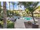 Beautiful community pool area with plenty of seating, tables, and lush landscaping with palm trees at 4343 N 21St St # 158, Phoenix, AZ 85016