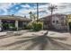 Gated community entrance with a guard house and lush desert landscaping with mature palm trees at 4343 N 21St St # 158, Phoenix, AZ 85016