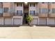 Multi-level condo complex with a palm tree and garage parking at 4343 N 21St St # 158, Phoenix, AZ 85016