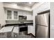 This bright kitchen features stainless steel appliances, stylish countertop, and white cabinets at 4343 N 21St St # 158, Phoenix, AZ 85016