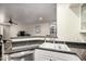 Bright kitchen with stone countertop offers bar access to living room at 4343 N 21St St # 158, Phoenix, AZ 85016