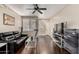 Bright living room features wood floors, ceiling fan, and view of an outdoor scene at 4343 N 21St St # 158, Phoenix, AZ 85016