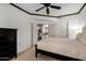 This bedroom features a ceiling fan, dark furniture, and a glimpse into the kitchen at 4343 N 21St St # 158, Phoenix, AZ 85016