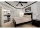 This bedroom grants access to the kitchen, featuring dark wood furniture and ceiling fan at 4343 N 21St St # 158, Phoenix, AZ 85016
