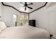 This bedroom boasts a ceiling fan, closet space, and balcony access with natural light at 4343 N 21St St # 158, Phoenix, AZ 85016