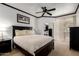 Spacious main bedroom with ceiling fan, dark wood furniture, and walk-in closet access at 4343 N 21St St # 158, Phoenix, AZ 85016