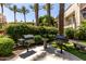Community outdoor area with two grills, table, and landscaped bushes and palm trees at 4343 N 21St St # 158, Phoenix, AZ 85016