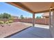Covered patio and backyard with raised garden beds and desert landscaping at 44092 W Stonecreek Rd, Maricopa, AZ 85139