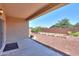 Covered patio and backyard with raised garden beds and desert landscaping at 44092 W Stonecreek Rd, Maricopa, AZ 85139