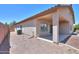 Exterior of house and covered patio with gravel landscaping in backyard at 44092 W Stonecreek Rd, Maricopa, AZ 85139