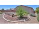 This backyard has raised garden beds bordered by concrete trim and decorative rock at 44092 W Stonecreek Rd, Maricopa, AZ 85139
